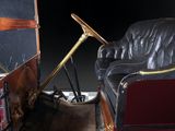 a black leather couch and a red leather chair in a room