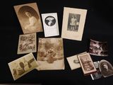 several old photographs of women and children are displayed on a table