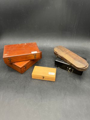 several different types of wooden boxes on a black surface