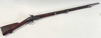 a rifle that is laying on top of a table
