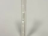 a glass beaker with a liquid in it on a white surface