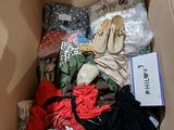 a cardboard box filled with clothes and other items