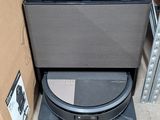 a black toilet sitting in a room next to a cardboard box