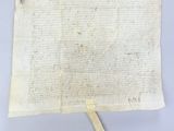 an old piece of paper with a burnt piece of wood sticking out of it