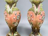 pair of pink and green vases sitting on top of a table