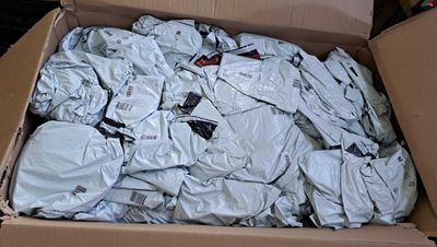 a cardboard box filled with a lot of clothes