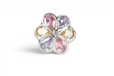 a close up of a flower shaped ring with multi colored stones