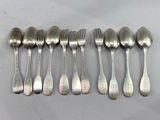 six spoons and six forks are lined up on a table