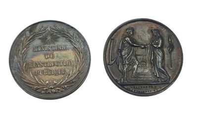 an old coin with a picture of a man and a woman on it