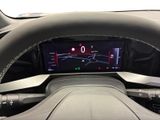the steering wheel of a car with a digital display on the dashboard