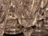 many empty wine glasses lined up on a table