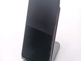 a cell phone that is sitting on top of a stand