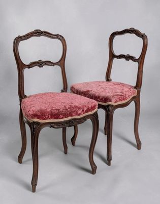 pair of antique chairs with red velvet upholstered seats