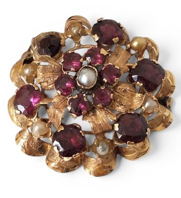 an image of a close up of a brooch with pearls and garnets