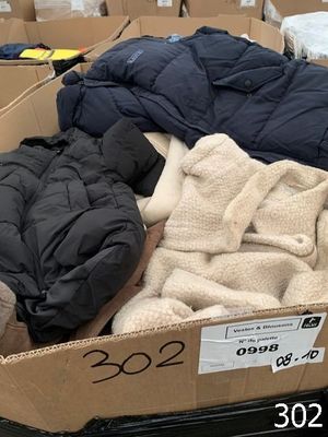 a cardboard box filled with blankets and blankets