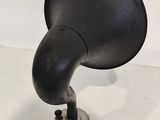 an old fashioned black speaker on a white surface
