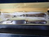 three knives in a box on a table