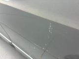 a close up of a car door with scratches on it