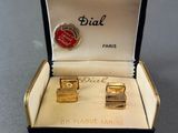 pair of gold plated cufflinks in a box with a red button