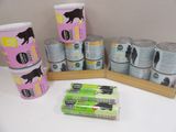 many cans of cat food sitting on a table