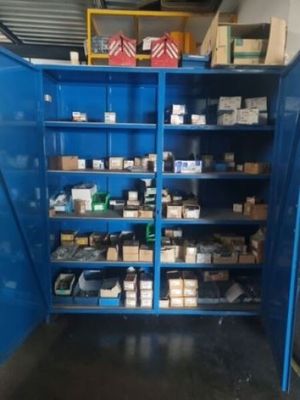 a blue storage cabinet with many items in it