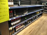 many bottles of wine on the shelves in the store