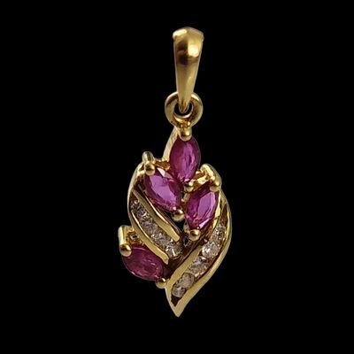 un pendentif en or orné de pierres roses et de diamants sur fond noir