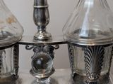 three glass vases on a silver tray with labels on them