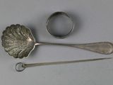 two spoons and a spoon rest on a table