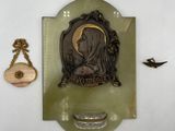 a picture of a plaque with a picture of a woman and a bird on it
