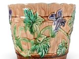 an image of a planter with flowers and leaves on it