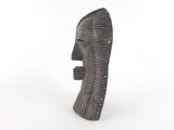 sculpture of a man ' s head on a white surface with a white background