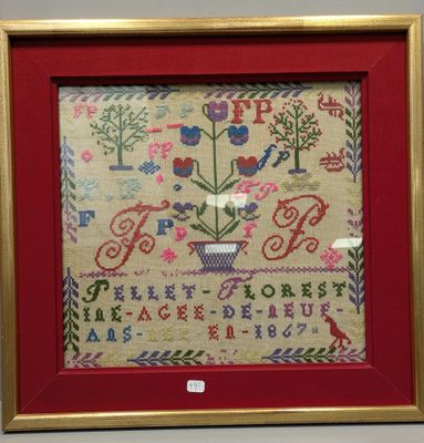 a framed picture of a cross stitch sample with a red frame and gold trim