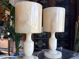 two lamps that are sitting on a glass table