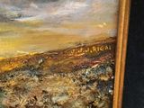 an oil painting of a landscape in a gold frame on a black background