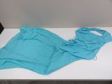 a blue shirt that is laying on a white table