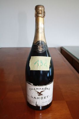 a bottle of champagne sitting on a table with a sticker on it