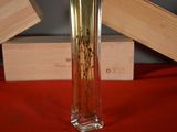a glass vase with flowers in it sitting on a red cloth
