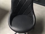 a black chair that is sitting in the corner of a room