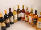 many bottles of wine that are lined up on the table