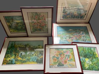 several framed pictures of flowers and trees are displayed in a display case