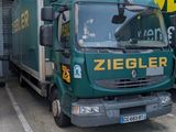 two trucks that are parked in front of a building
