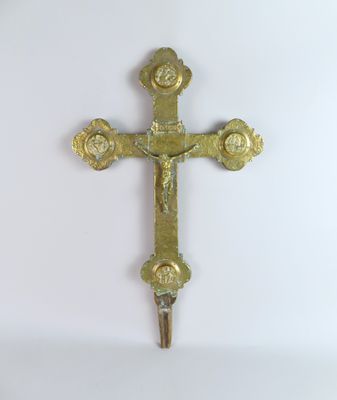 brass cross on a white background