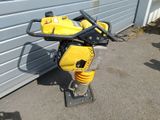 a small yellow machine that is sitting on the ground