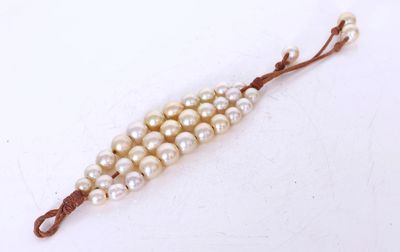 a close up of a string of pearls on a white surface