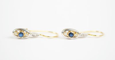 a pair of blue sapphire and diamond earrings on a white background