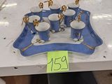 a tray with cups and saucers on it with a price tag