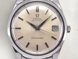 a silver watch with a brown face on a white surface