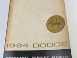 a close up of a book on a table with a clock on it