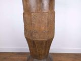 a wooden vase sitting on a wooden floor